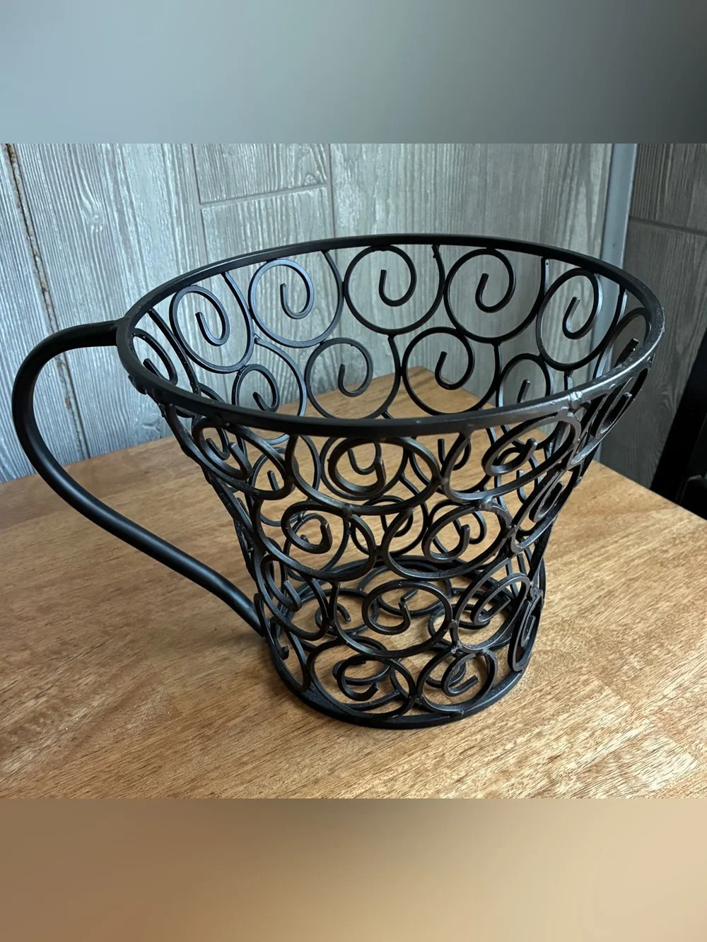wrought iron decorative basket shaped like a large coffee mug or teacup,
